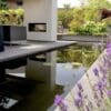 Little Island surrounded by a pond with a fireplace and a sofa in the middle