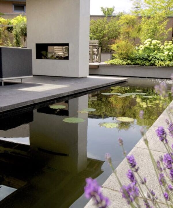 Little Island surrounded by a pond with a fireplace and a sofa in the middle