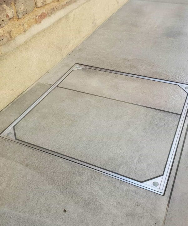 Alusthetic double sealed manhole cover installed outdoors with tile slab infill