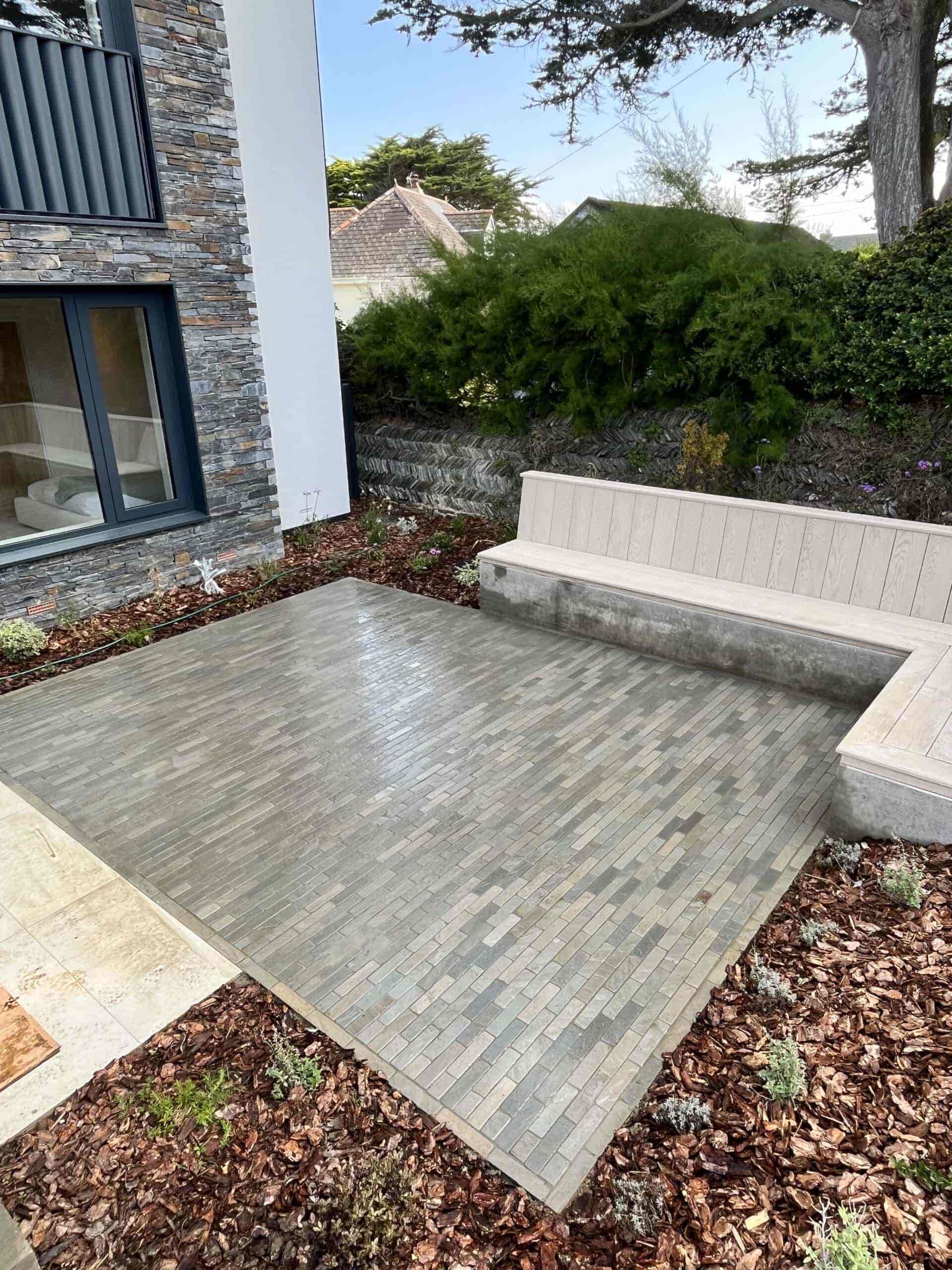 Kandla Grey Setts on a patio in a garden