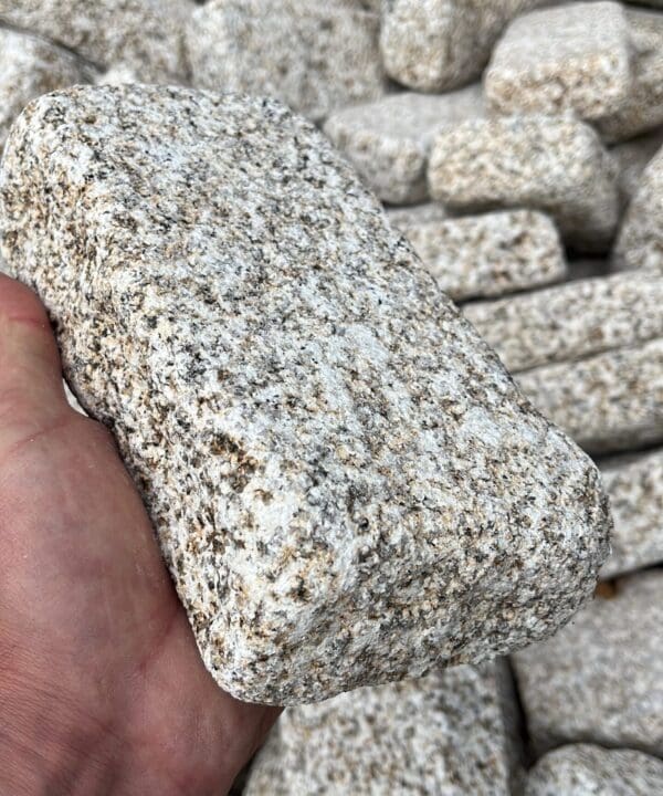 Beige Sawn Faced Granite Setts in a hand